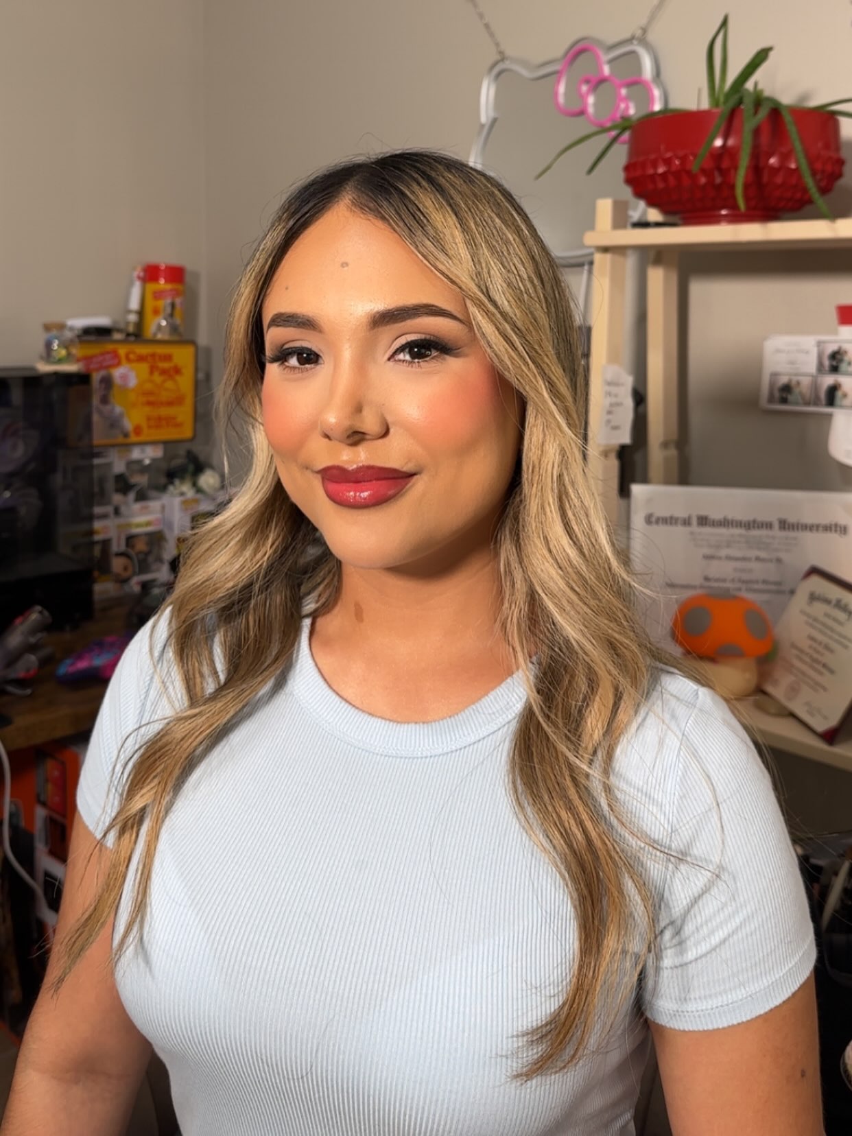 Client wearing rosy cheeks, defined brows, and a satin rose lip